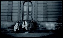 Sacred Hearts Fathers James Beynes, Bruno Bens, Urich Taube, and Francis Steffen sitting on the front steps of Maria Lanakila Church, Lahaina, Maui.